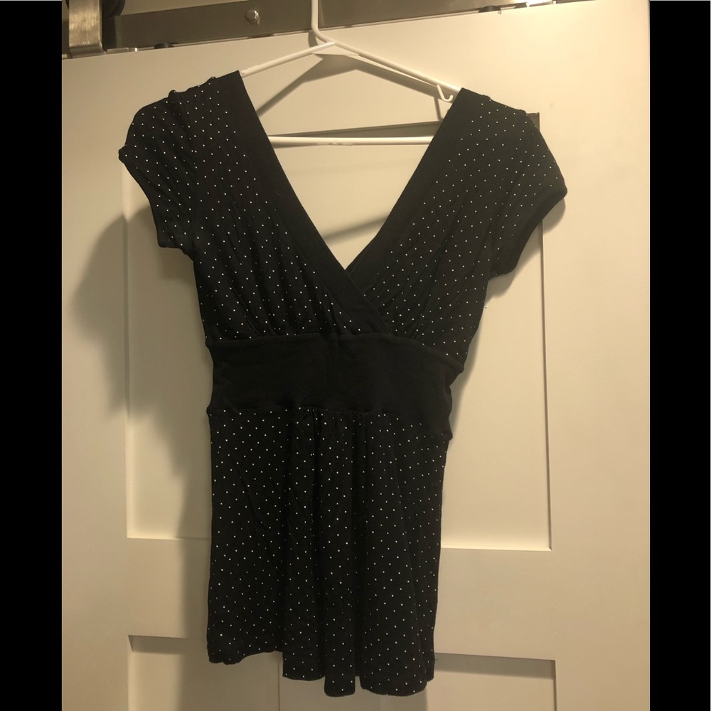 Fitted v-neck top with cap sleeves.